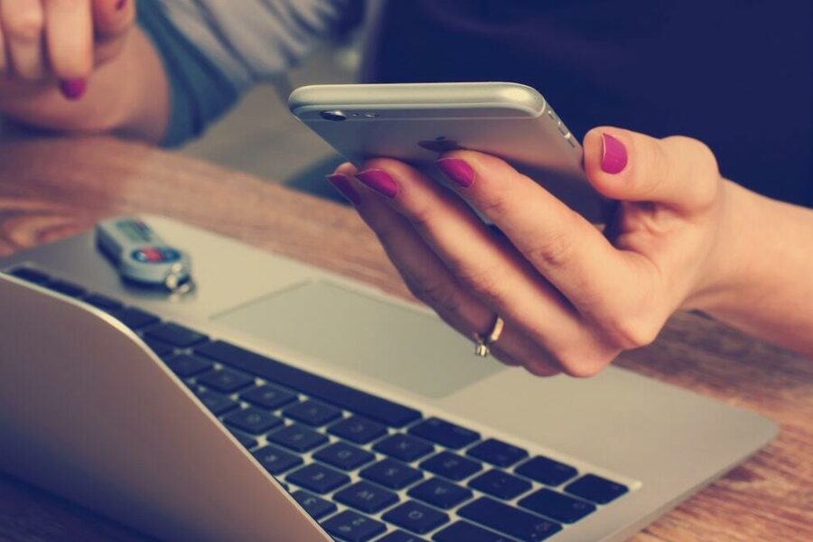 Woman with Phone and Laptop