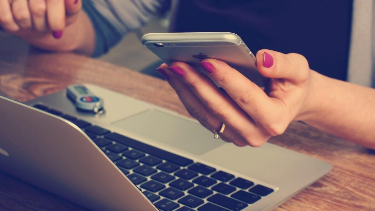 Woman with Phone and Laptop